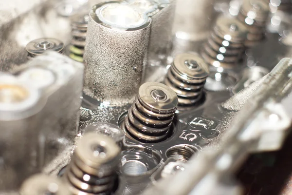 Mechanic hands tighten nut with wrench while repairing engine