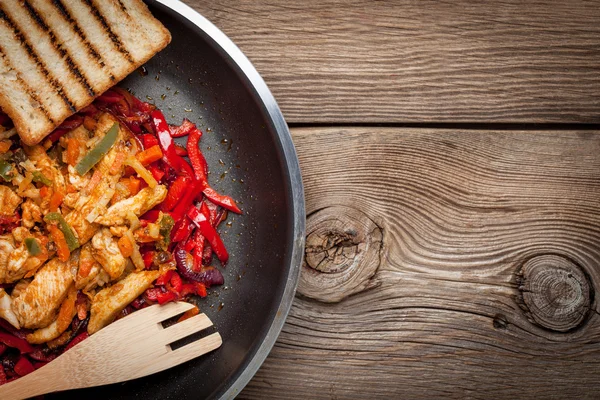 Fried chicken pieces with vegetables.