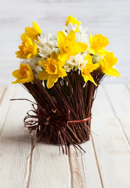 Daffodils in a twig vase