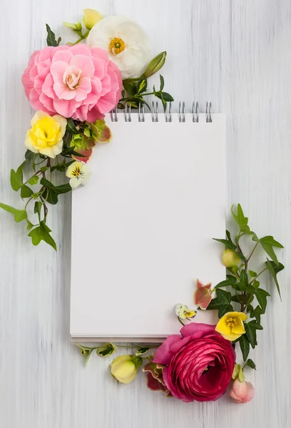 Flowers and notepad with copy space