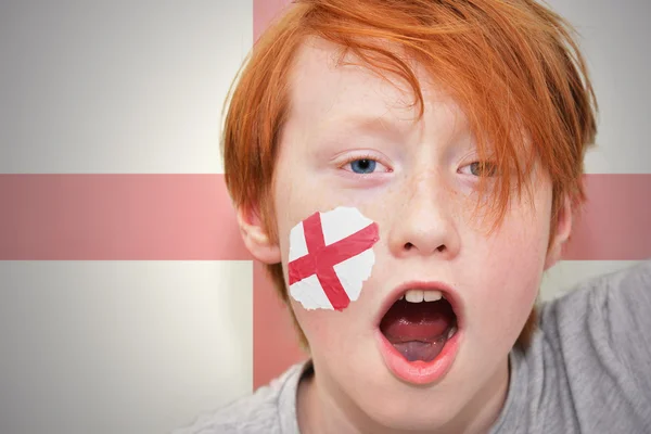 Redhead fan boy with english flag painted on his face