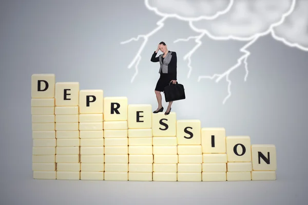 Businesswoman standing on a text on depression, on a gray background.