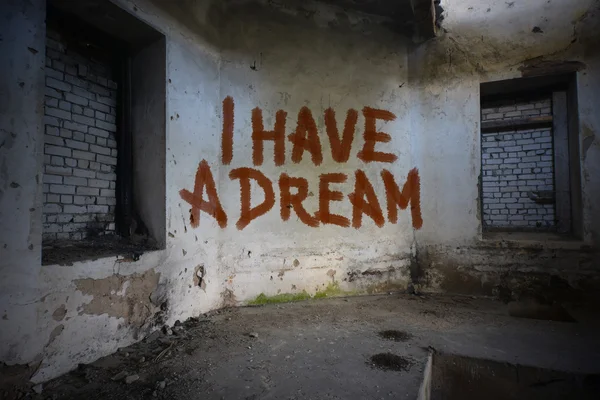 Text i have a dream on the dirty old wall in an abandoned ruined house