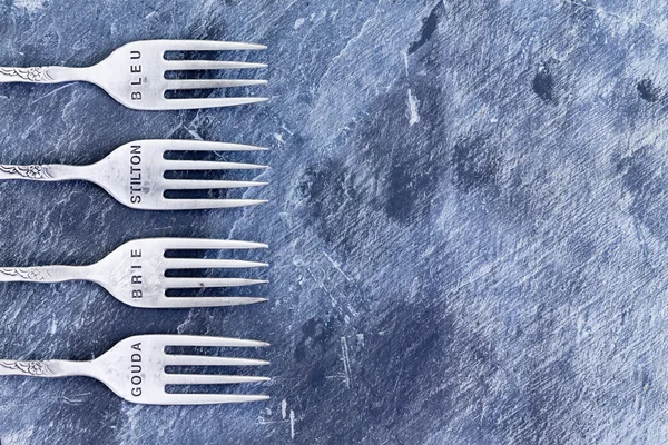 Blue textured background with silver forks