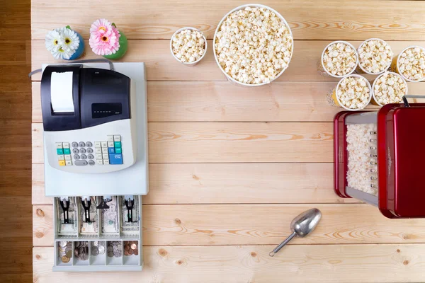 Bowls of fresh popcorn alongside a till