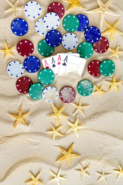 Conceptual Sand with Stars, Poker Chips and Cards