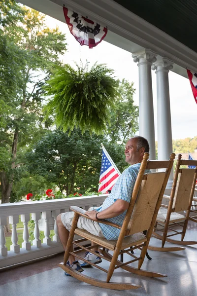 Sitting Adult Man at the Terrace with USA Flags