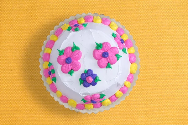 Iced cake with colorful flowers