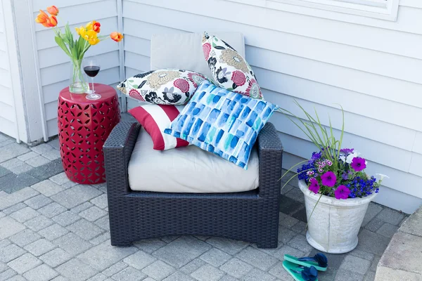 Pile of colorful cushions on an outdoor armchair