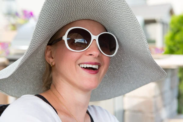 Woman in Hat and Sunglasses Laughing Outdoors