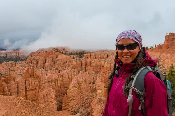 Hiker looking down a Peek-a-boo loop trail Bryce Canyon