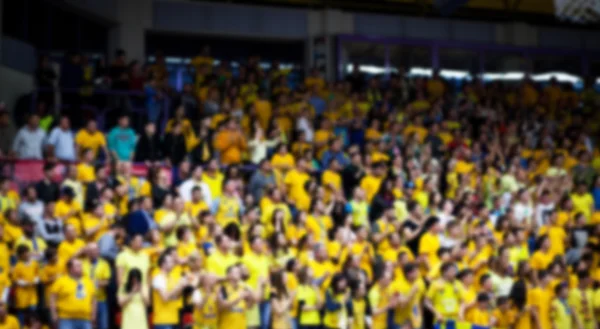 Blurred background of crowd of people in a basketball court