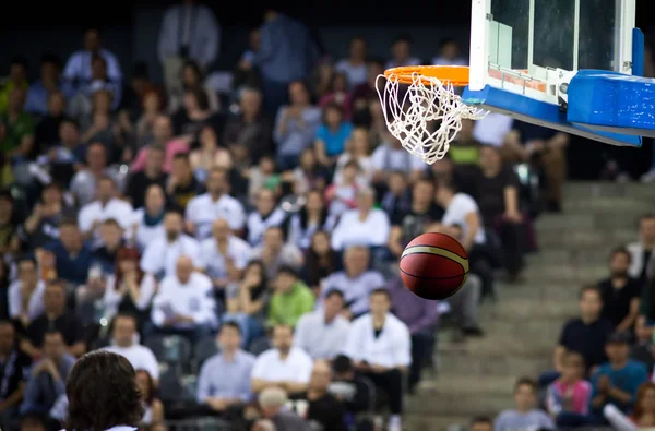 Basketball going through the hoop at a sports arena