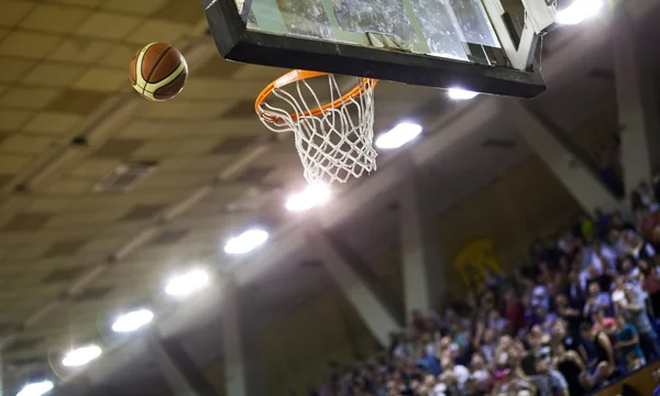 Basketball going through the hoop at a sports arena