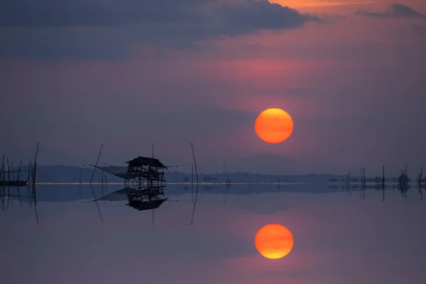 Mirror image of Sunset at the lake, Thailand.