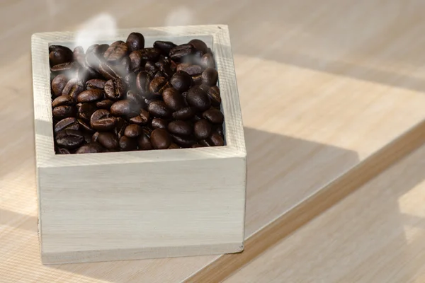 Roasted coffee beans in the wood box.