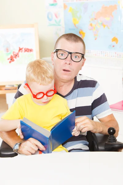 Disable father reading with little son