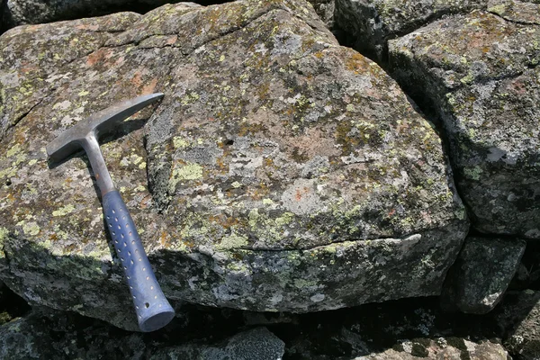 Basalt rock and hammer