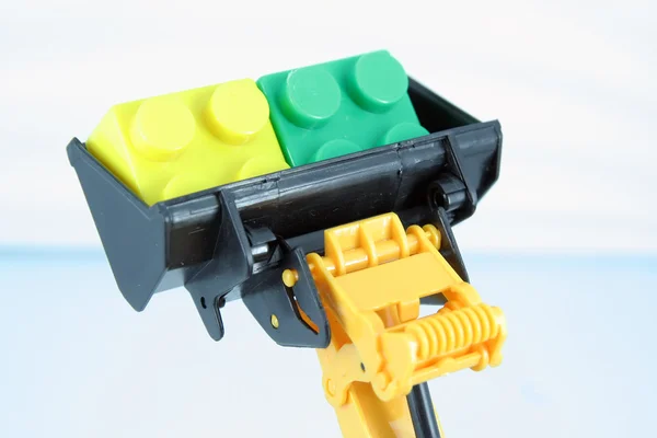 Bulldozer toy with colorful cubes.