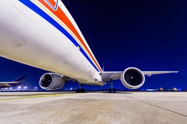 Commercial airplane parking at night