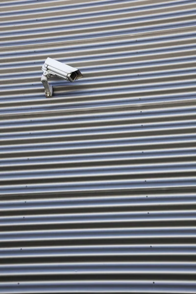 Camera on corrugated iron building