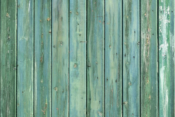 Wooden wall of shed consisiting of blue green planks