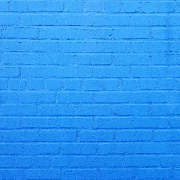 Square part of blue painted brick wall