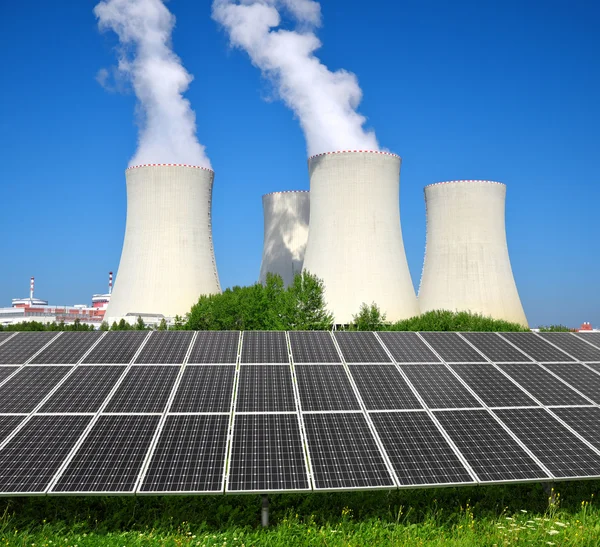 Solar energy panels before a nuclear power plant