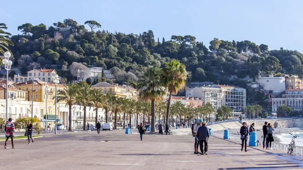 NICE, FRANCE - on JANUARY 7, 2016. Tourists walk on Promenade des Anglais, one of the most beautiful embankments of Europe