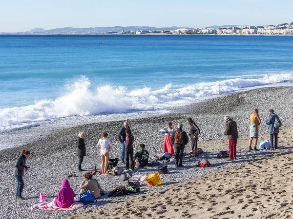 NICE, FRANCE - on JANUARY 13, 2016. People have a rest on the city beach in the winter sunny day