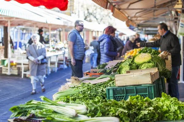 NICE, FRANCE, on JANUARY 13, 2016. Buyers in the market choose vegetables and fruit