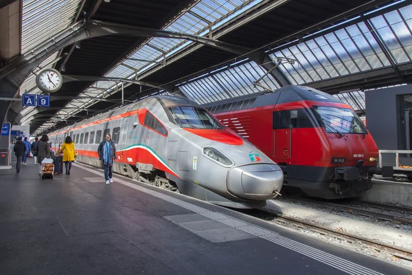 ZURICH, SWITZERLAND, on MARCH 26, 2016. Railway station. The modern high-speed train at the platform. Passengers go on the platform.