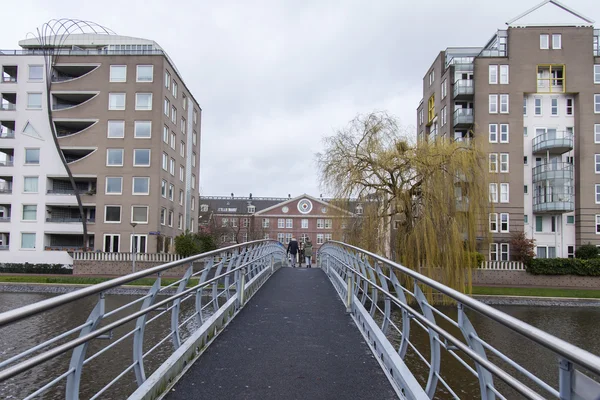 AMSTERDAM, NETHERLANDS on MARCH 27, 2016. Typical urban view in the spring morning. The bridge through the river Amstel