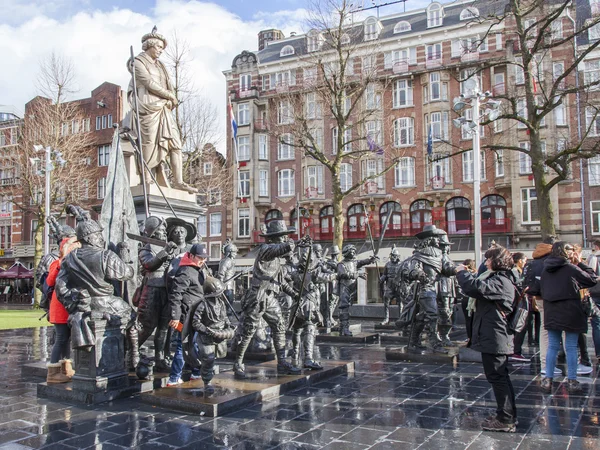 AMSTERDAM, NETHERLANDS on MARCH 27, 2016. Sculptural composition Night watch at Rembrandt Square - one of sights of the city. Tourists walk among figures and are photographed