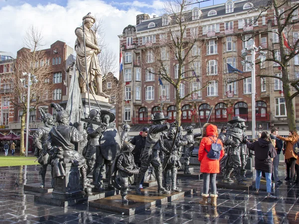 AMSTERDAM, NETHERLANDS on MARCH 27, 2016. Sculptural composition Night watch at Rembrandt Square - one of sights of the city. Tourists walk among figures and are photographed