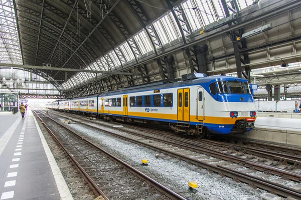 AMSTERDAM, NETHERLANDS on APRIL 1, 2016. Railway station. The modern high-speed train at the platform. Passengers go on the platform.