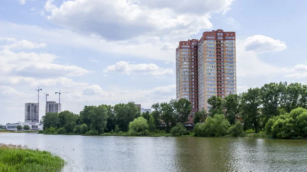 PUSHKINO, RUSSIA, on MAY 30, 2016. City landscape. Multystoried houses on the river bank of Serebryanka