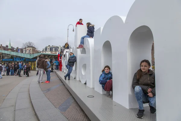 AMSTERDAM, NETHERLANDS on MARCH 31, 2016. Letters of the inscription I AMsterdam on the museum square - one of city symbols. Tourists have a good time.