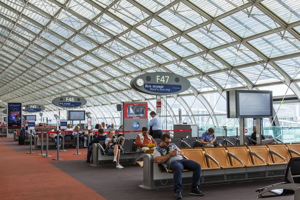 PARIS, FRANCE, on JULY 12, 2016. Passengers expect a flight gate in the hall of departures of the terminal 2F at the airport Charles de Gaulle