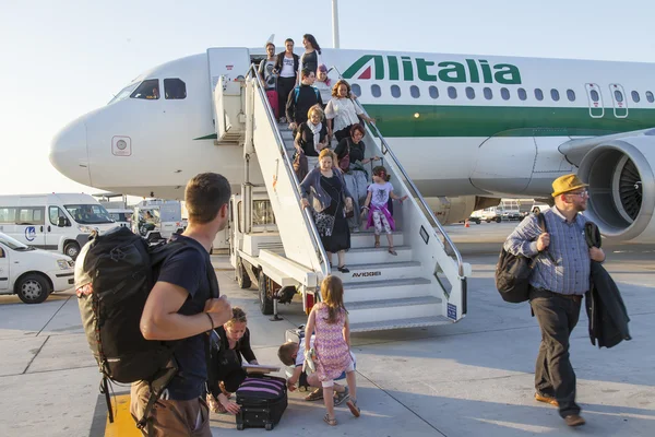 PARIS, FRANCE, on JULY 12, 2016. Passengers go out of the plane of Alitalia airline at the airport Charles de Gaulle