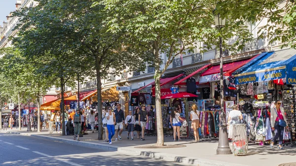 PARIS, FRANCE, on JULY 7, 2016. Picturesque city street. People buy souvenirs and gifts in shops