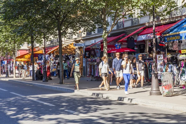 PARIS, FRANCE, on JULY 7, 2016. Picturesque city street. People buy souvenirs and gifts in shops