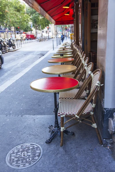 PARIS, FRANCE, on JULY 7, 2016. Typical Parisian street in the morning. Little tables of cafe under the open sky.