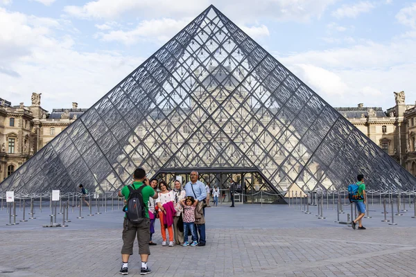 PARIS, FRANCE, on JULY 11, 2016. A glass pyramid of Louvre in Napoleon\'s (cour Napoleon) yard, a main entrance in Louvre, one of city symbols. Architect of Ieoh Ming Pei