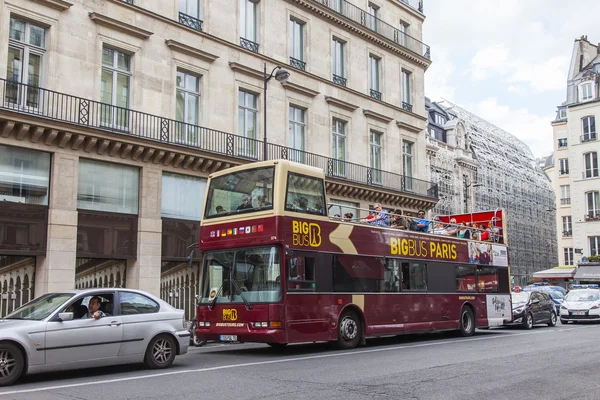 PARIS, FRANCE, on JULY 7, 2016. The typical city street with historical building. The excursion bus goes down the street