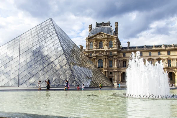 PARIS, FRANCE, on JULY 11, 2016. A glass pyramid of Louvre in Napoleon's (cour Napoleon) yard, a main entrance in Louvre, one of city symbols. Architect of Ieoh Ming Pei