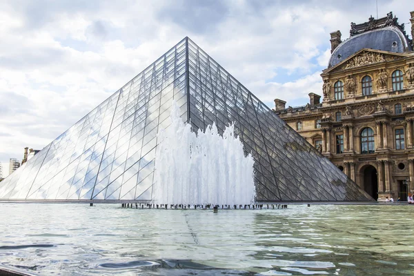 PARIS, FRANCE, on JULY 11, 2016. A glass pyramid of Louvre in Napoleon\'s (cour Napoleon) yard, a main entrance in Louvre, one of city symbols. Architect of Ieoh Ming Pei
