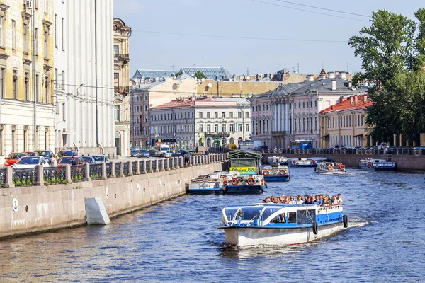 ST. PETERSBURG, RUSSIA, on August 21, 2016. The walking ship with tourists floats down the river Moika. Architectural complex of the embankment.