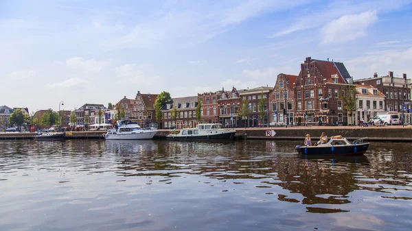 Haarlem, Netherlands, on July 11, 2014. A typical urban view with old buildings on the bank of the channel.