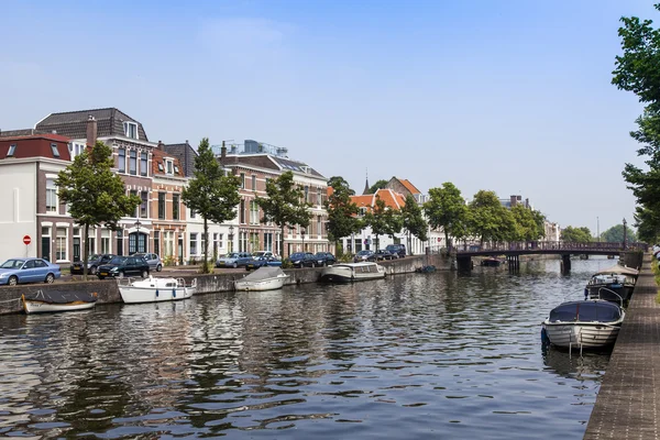 Haarlem, Netherlands, on July 11, 2014. Typical urban view with old buildings on the bank of the channel